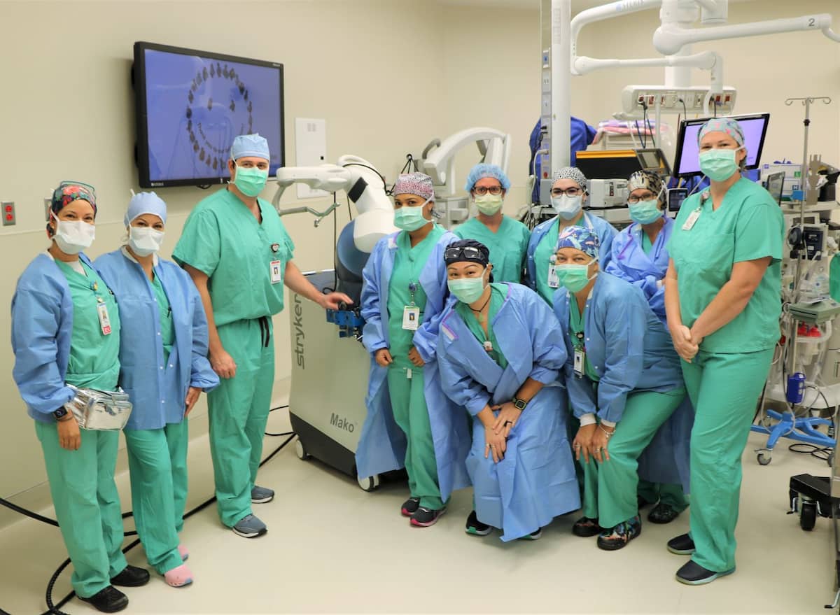 Dr. Avino surgical team with Mako robotic system in operating room